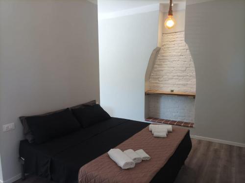 a bedroom with a bed with two towels on it at Lucca&Joy Apartment in Lucca