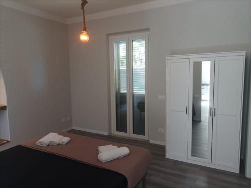 a bedroom with a bed with two white towels on it at Lucca&Joy Apartment in Lucca