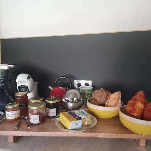 a table with bread and other food items on it at La babounette in Jaujac