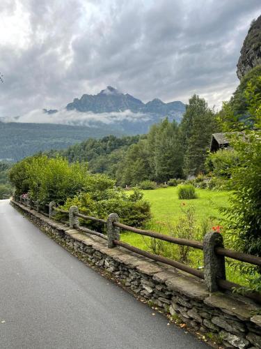 a wooden fence on the side of a road at Le Primule in Piedilago