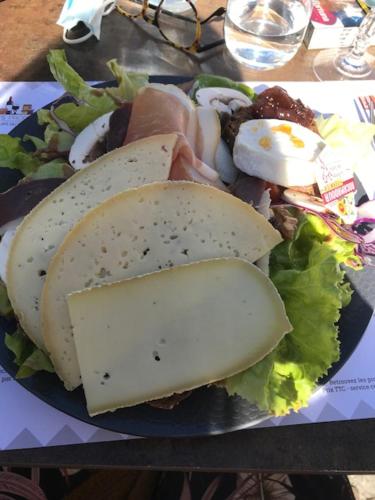 a plate of food with a sandwich and a salad at Ratatouille in Mayrinhac-Lentour