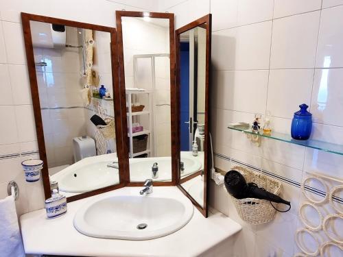 a bathroom with a sink and a mirror at Little Paradise in Taormina