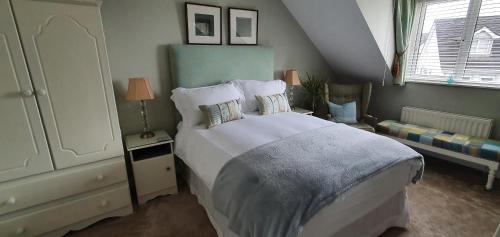a bedroom with a large bed and a window at Grove Bed & Breakfast in Coleraine