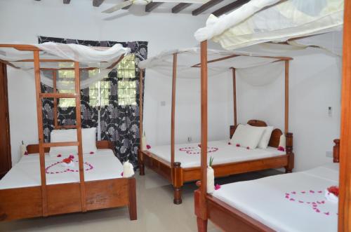 En eller flere senger på et rom på Bagamoyo Spice Villa