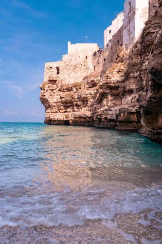 a castle on a cliff next to the ocean at Quattro Perle in Polignano a Mare
