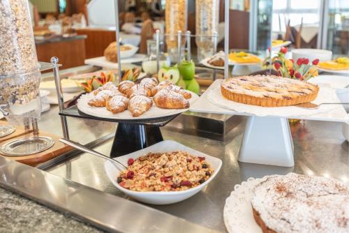 a buffet with many different types of food on display at Hotel Splendid Palace in Limone sul Garda