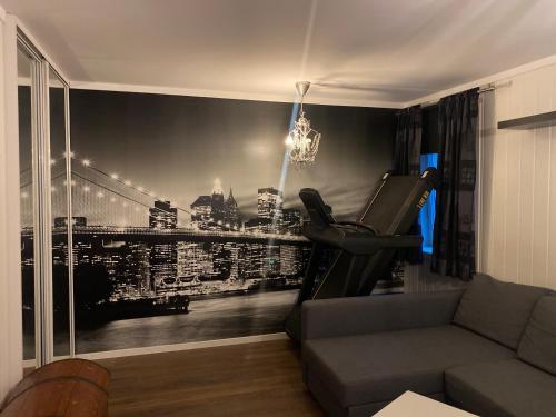 a living room with a wall mural of a city at Mona in Trondheim