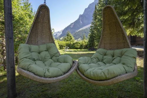 two chairs sitting in the grass in a yard at Seilers Vintage Hotel & Spa in Kandersteg