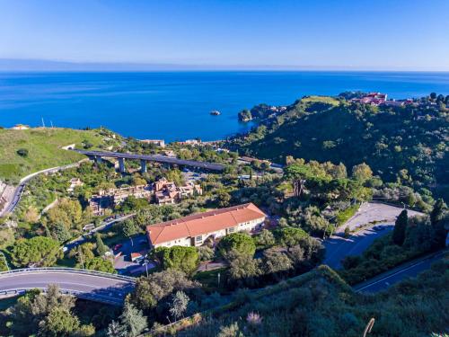 an aerial view of a house on a hill next to the ocean at Little Paradise in Taormina