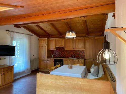 a kitchen with wooden cabinets and a table with a box at Chalet Forciagn in San Vigilio Di Marebbe