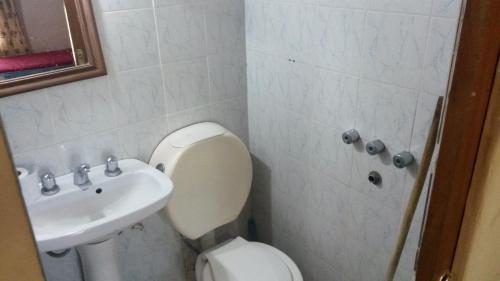 a bathroom with a toilet and a sink at Posada Los Balnearios in San Pedro