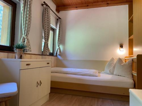 a small bedroom with a bed in a room at Chalet Forciagn in San Vigilio Di Marebbe