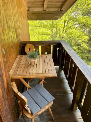 a wooden table and a chair on a porch at Chalet Forciagn in San Vigilio Di Marebbe