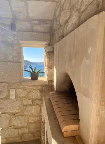 a stairway in a stone building with a window at Stonehouse villas with breathtaking view in Sitia