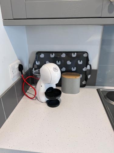 a pretend kitchen with a hair dryer on the counter at Sparkling Space - Twin or King Beds in Bangor