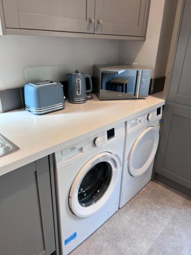 a kitchen with a washer and dryer on a counter at Sparkling Space - Twin or King Beds in Bangor