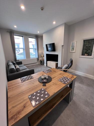 a living room with a table and a couch at Sparkling Space - Twin or King Beds in Bangor