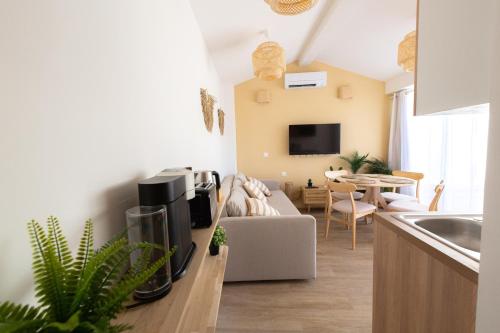 a kitchen and living room with a couch and a living room at La Terrasse du Palais in Avignon