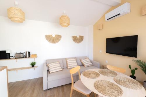 a living room with a couch and a table at La Terrasse du Palais in Avignon