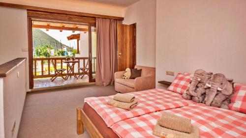 a bedroom with a bed and a couch and a balcony at Seaside resort Vasiliki in Vasiliki