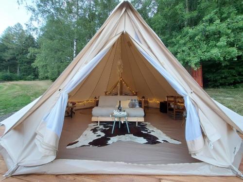 a tent with a couch and a table in it at Apartmány Tollendorf Lužické hory in Jiřetín pod Jedlovou