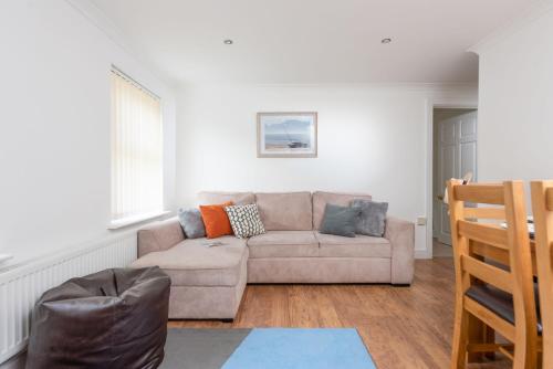 a living room with a couch and a chair at Rosebud in Portreath