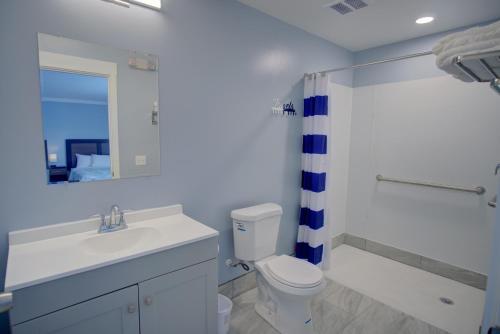a bathroom with a sink and a toilet and a shower at Dhimas Bayview Suites in Ocean City