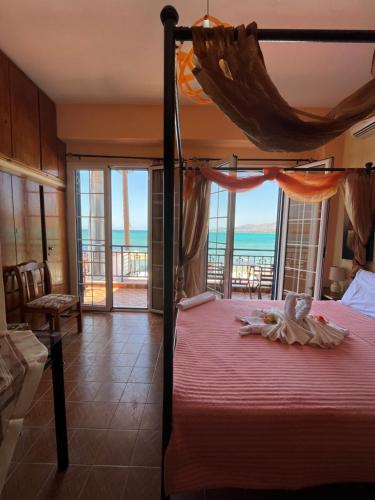 a bedroom with a bed with a view of the ocean at Ηλιοβασίλεμα in Elafonisos