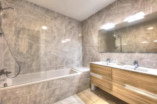 a bathroom with a tub and a sink and a shower at Appartement 60M2 - TELECABINE SAINT GERVAIS - 201 in Saint-Gervais-les-Bains