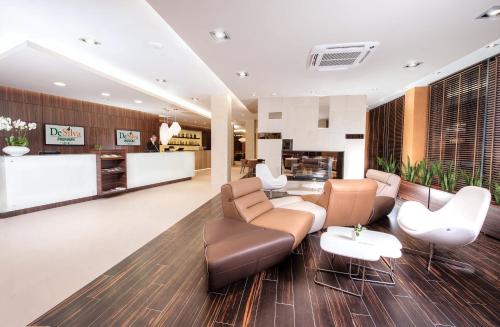 a lobby of a hotel with a couch and chairs at Hotel DeSilva Premium Opole in Opole