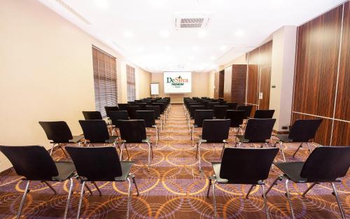 a large room with rows of chairs on a carpet at Hotel DeSilva Premium Opole in Opole