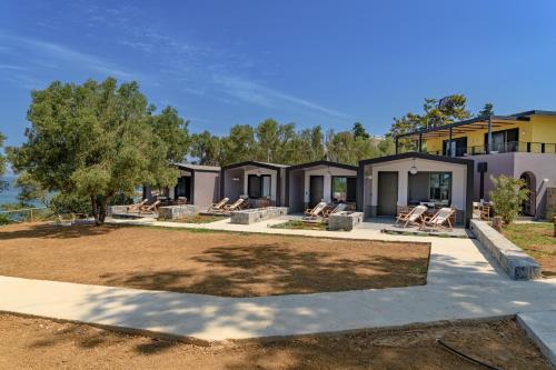 a house with a yard with chairs and a tree at Via Lassi Kefalonia in Argostoli