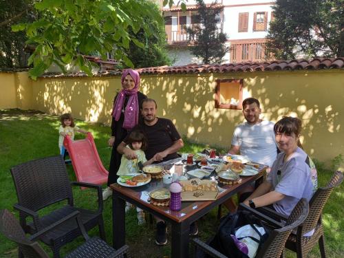 a group of people sitting at a table eating food at SARI KONAK Garden Otel Safranbolu in Safranbolu