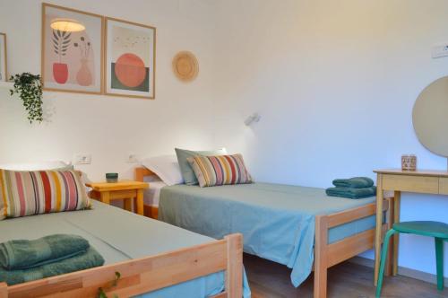 a room with two beds and a table and a couch at Apartman Paula in Milna