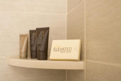 a book sitting on a shelf in a bathroom at Ayres Hotel & Spa Moreno Valley/Riverside in Moreno Valley