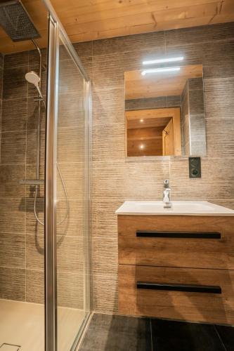 a bathroom with a sink and a shower at CHALET LES CERFS in Châtel