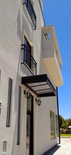 a white building with balconies on the side of it at BY DANIELS in Federación