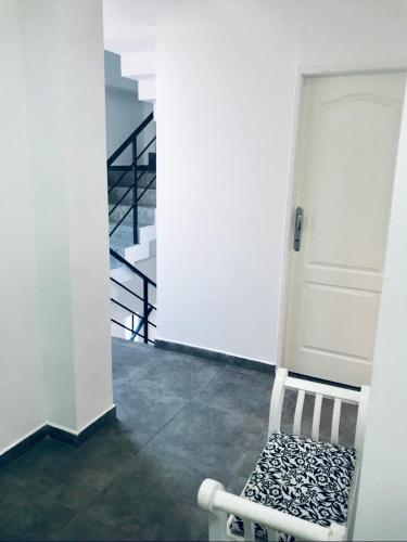 a room with a white door and a white chair at BY DANIELS in Federación