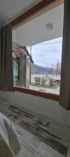 a window in a bedroom with a view of a street at Puerto La Casa in San Martín de los Andes