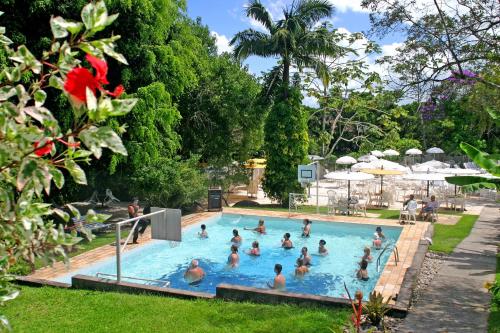 a group of people in a swimming pool at Plaza Caldas da Imperatriz Resort & Spa in Santo Amaro da Imperatriz