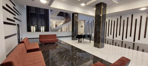 a lobby with chairs and a piano in a building at Via Tsaghkadzor in Tsaghkadzor