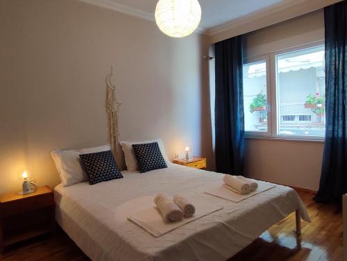 a bedroom with a large bed with towels on it at Emme Central - spacious apartment in Kavala