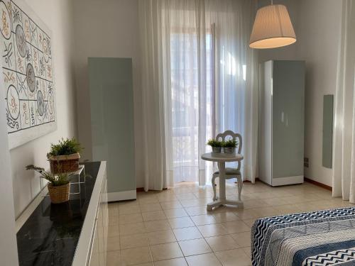 a bedroom with a bed and a table and a window at WestHouse in Pescara