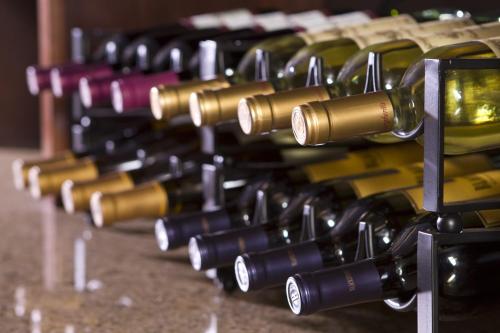 a row of wine bottles on a table at ALO Hotel by Ayres, Orange in Anaheim