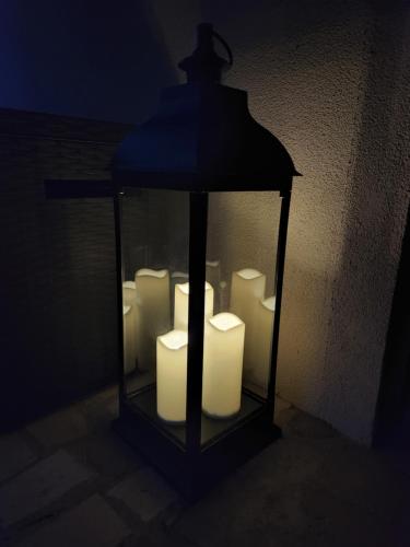 a lantern filled with white candles in a dark room at Botanica Zlatibor in Zlatibor