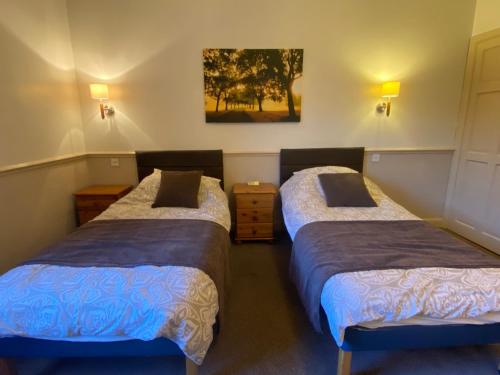 um quarto com duas camas e um quadro na parede em Queens Ground em Sheffield