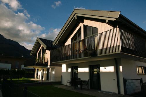a house with a balcony and a table in front of it at Wia dahoam in Leogang