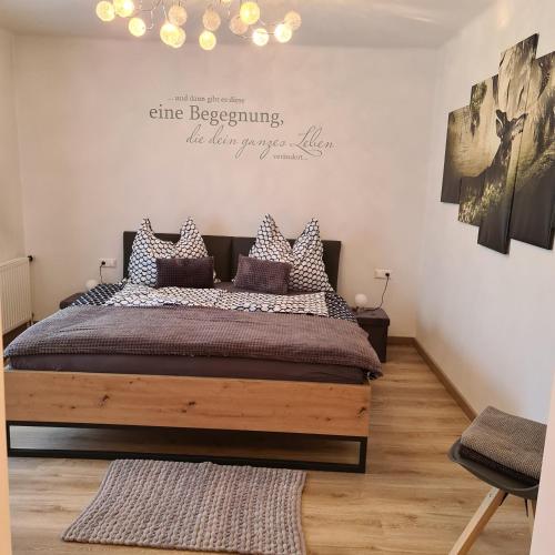 a bedroom with a bed and a chandelier at Ferienwohnung Claudia in Altossiach