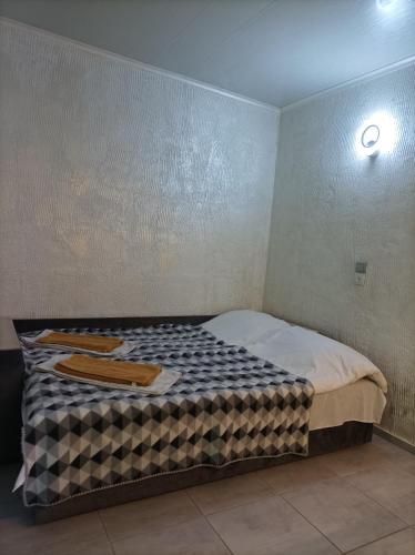a small bedroom with a bed in a room at House&House 84 in Petropavlovskaya Borshchagovka