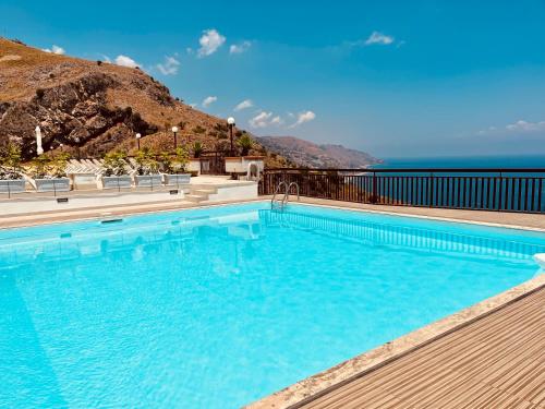 a swimming pool with a view of the ocean at Little Paradise in Taormina